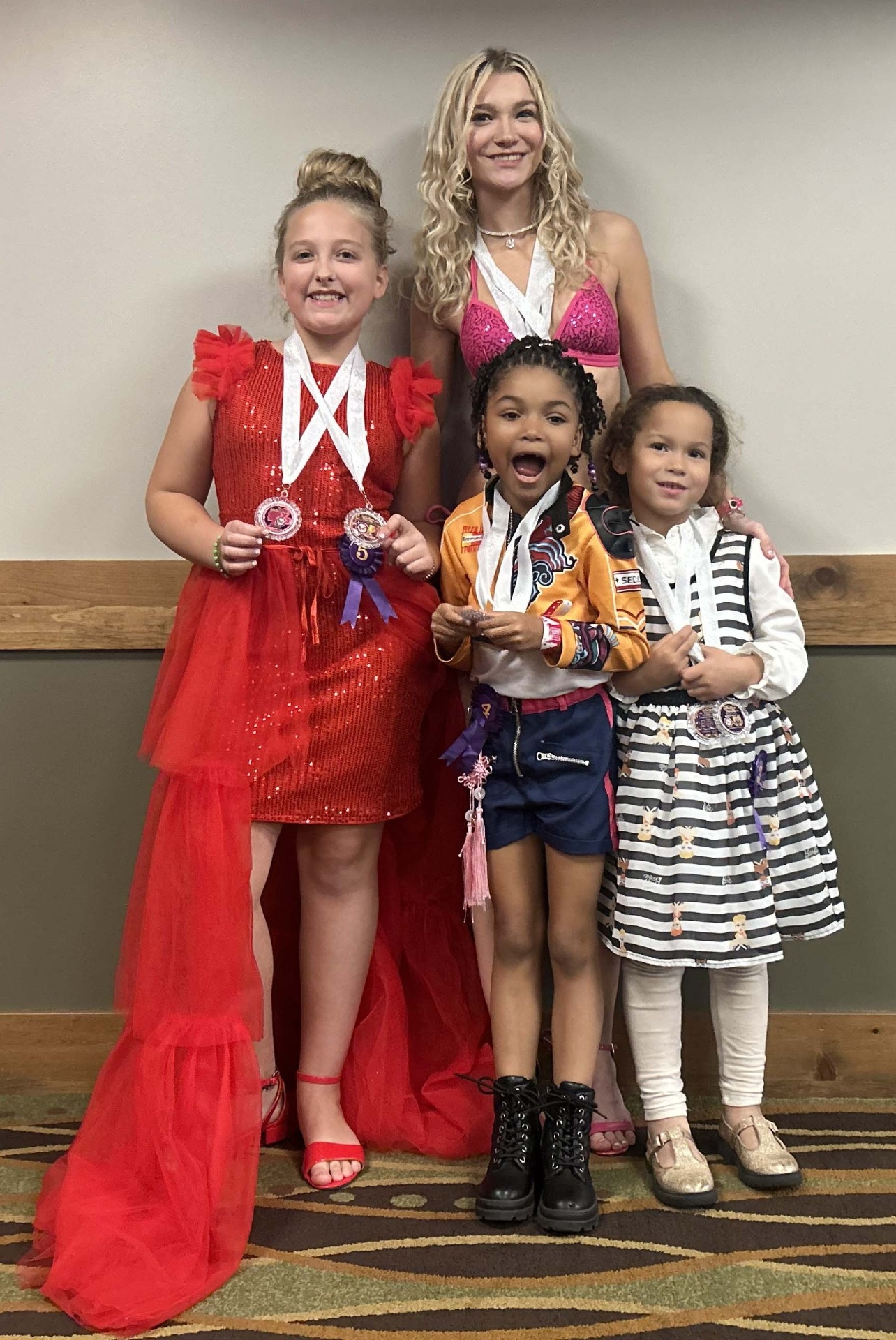Titleholders posing with awards and medals